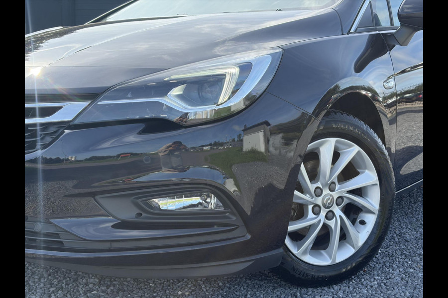 Opel Astra Sports Tourer 1.4 Business Executive ✓2 Eigenaar✓Camera✓Navi✓Trekhaakt✓Carplay✓Stoelverw✓Stuurverw✓Automaat✓Dealer Onderhouden✓Keyless✓Clima✓Cruise✓Pdc V+A✓Halfleder✓Comfortstoelen✓150pk✓Rijstrooksensor✓Dodehoeksensor✓Elekt Stoelen✓Lm velgen✓N.A.P✓Apk tot 03-2027