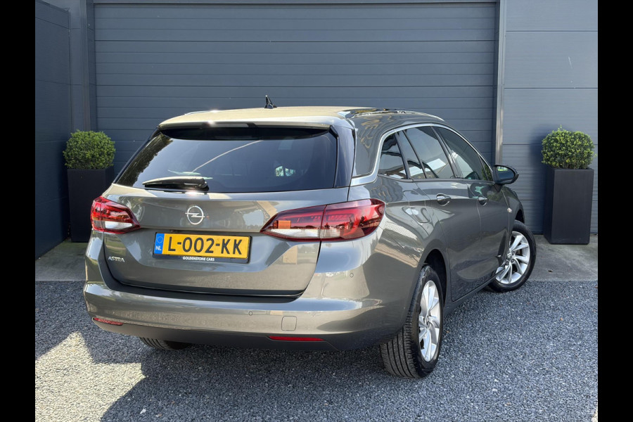 Opel Astra Sports Tourer 1.2 Business Elegance ✓1e Eigenaar✓110pk✓Carplay✓Camera✓Navi✓Clima✓Cruise✓Halfleder✓Comfortstoel✓Pdc V+A✓6 Bak✓Dealer Onderhouden✓Keyless✓Lm velgen✓N.A.P✓Apk tot 06-2027