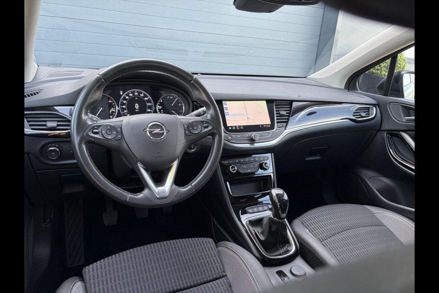 Opel Astra Sports Tourer 1.2 Business Elegance ✓1e Eigenaar✓110pk✓Carplay✓Camera✓Navi✓Clima✓Cruise✓Halfleder✓Comfortstoel✓Pdc V+A✓6 Bak✓Dealer Onderhouden✓Keyless✓Lm velgen✓N.A.P✓Apk tot 06-2027