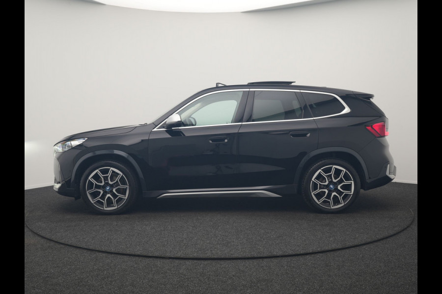 BMW iX1 xDrive30 X Line 67 kWh 313pk Dealer O.H. | Trekhaak Af Fabriek | Panodak | Head Up | Adaptive Cruise | 360 Camera | Harman / Kardon | Lederen Sportstoelen Massage & Memory | Keyless | Sfeerverlichting | Stoelen & Stuur Verwarmd | Apple Carplay | Widescreen Navi | DAB | 19"L.M |