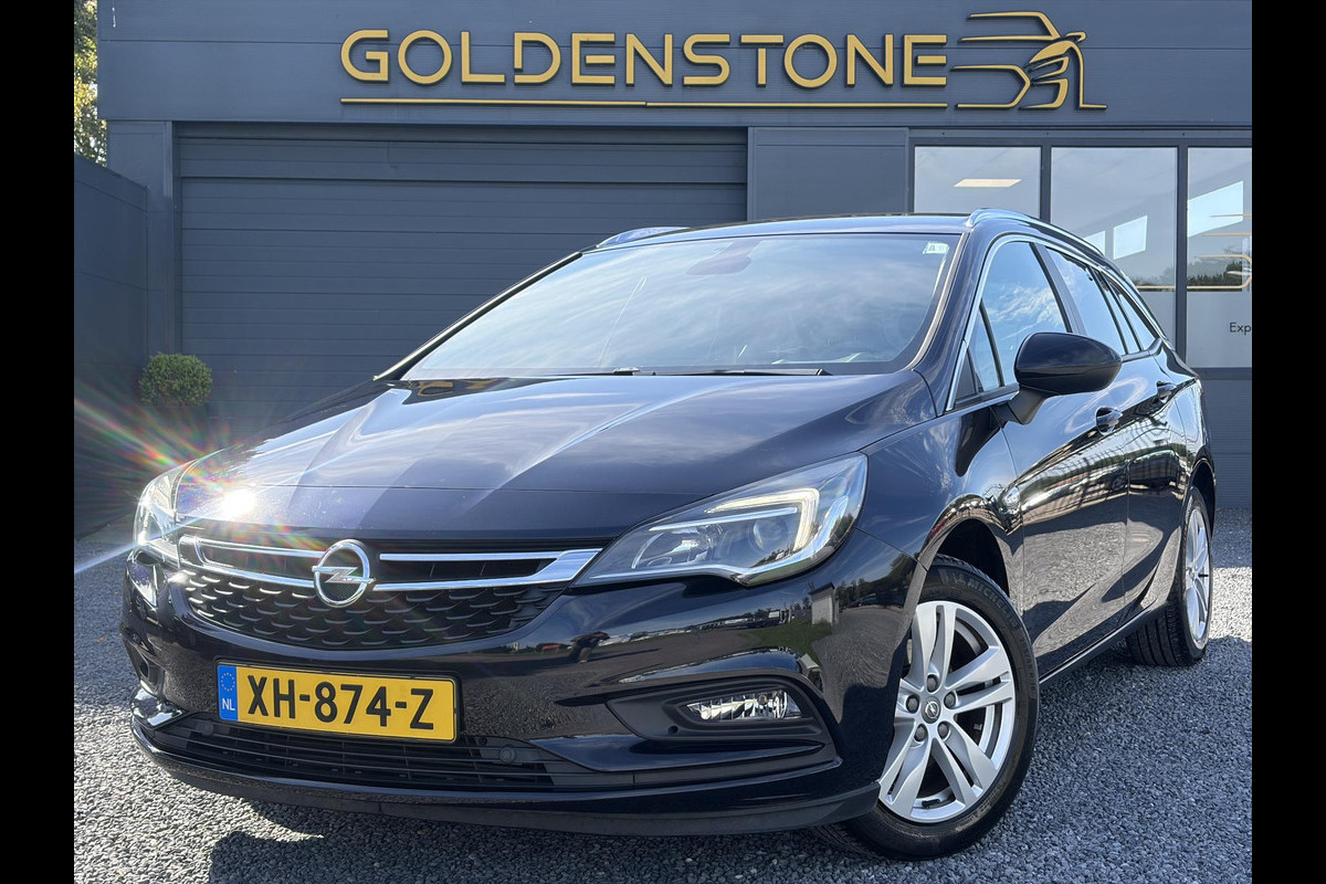 Opel Astra Sports Tourer 1.4 Turbo Online Edition ✓150pk✓2e Eigenaar✓Camera✓Carplay✓Navi✓Pdc V+A✓Stoelverw✓Stuurverw✓Clima✓Cruise✓Lm velgen✓6 Bak✓Comfortstoelen✓Dealer Onderhouden✓N.A.P✓Bj 12-2018✓Apk tot 01-2027