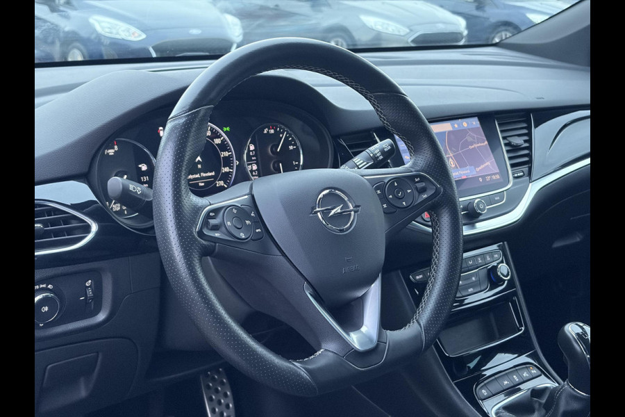 Opel Astra Sports Tourer 1.2 Elegance ✓110pk✓Camera✓Carplay✓Navi✓Halfleder✓Keyless✓Trekhaak✓Pdc V+A✓Clima✓Cruise✓Elekt Stoel✓Recent beurt gehad✓Dodehoeksensor✓Rijstrooksensor✓Lm velgen✓N.A.P✓Apk tot 11-2027