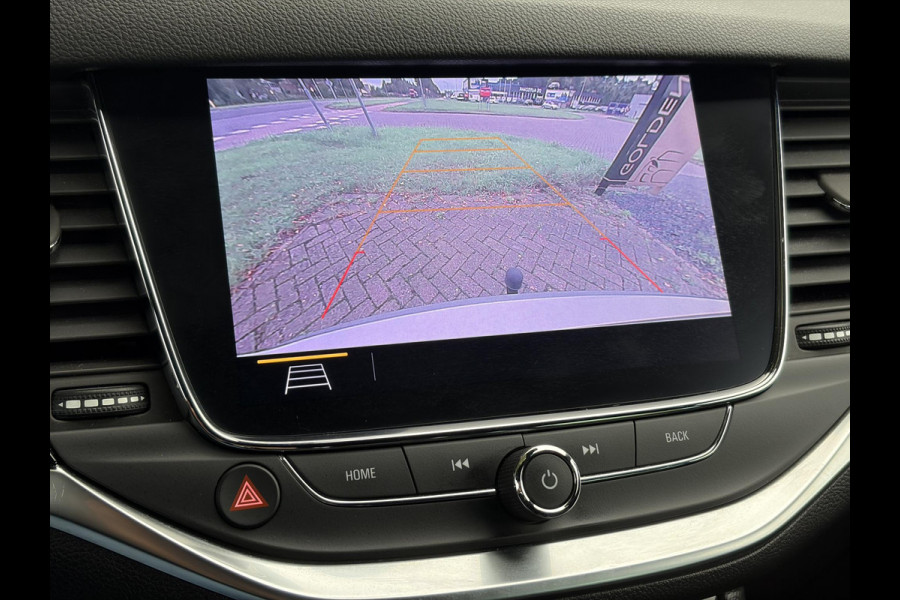 Opel Astra Sports Tourer 1.2 Elegance ✓110pk✓Camera✓Carplay✓Navi✓Halfleder✓Keyless✓Trekhaak✓Pdc V+A✓Clima✓Cruise✓Elekt Stoel✓Recent beurt gehad✓Dodehoeksensor✓Rijstrooksensor✓Lm velgen✓N.A.P✓Apk tot 11-2027