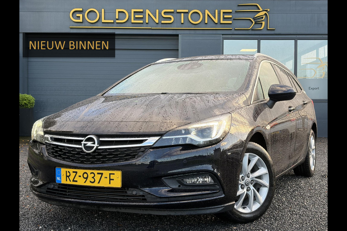 Opel Astra Sports Tourer 1.4 Innovation ✓Trekhaak✓Camera✓Carplay✓Navi✓Recent beurt gehad✓150pk✓Keyless✓Halfleder✓6 Bak✓Rijstrooksensor✓Dodehoeksensor✓Pdc V+A✓Lm velgen✓Clima✓Cruise✓N.A.P✓Apk tot 09-2027