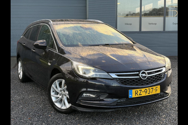 Opel Astra Sports Tourer 1.4 Innovation ✓Trekhaak✓Camera✓Carplay✓Navi✓Recent beurt gehad✓150pk✓Keyless✓Halfleder✓6 Bak✓Rijstrooksensor✓Dodehoeksensor✓Pdc V+A✓Lm velgen✓Clima✓Cruise✓N.A.P✓Apk tot 09-2027