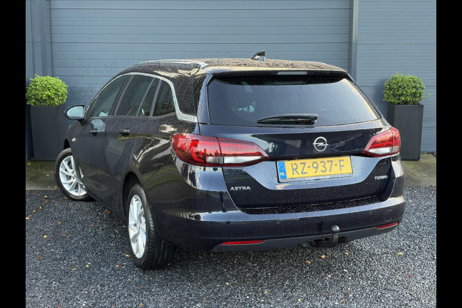 Opel Astra Sports Tourer 1.4 Innovation ✓Trekhaak✓Camera✓Carplay✓Navi✓Recent beurt gehad✓150pk✓Keyless✓Halfleder✓6 Bak✓Rijstrooksensor✓Dodehoeksensor✓Pdc V+A✓Lm velgen✓Clima✓Cruise✓N.A.P✓Apk tot 09-2027