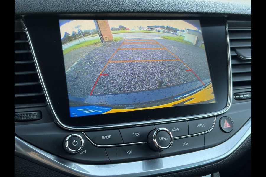Opel Astra Sports Tourer 1.4 Innovation ✓Trekhaak✓Camera✓Carplay✓Navi✓Recent beurt gehad✓150pk✓Keyless✓Halfleder✓6 Bak✓Rijstrooksensor✓Dodehoeksensor✓Pdc V+A✓Lm velgen✓Clima✓Cruise✓N.A.P✓Apk tot 09-2027