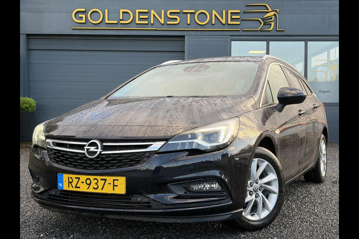 Opel Astra Sports Tourer 1.4 Innovation ✓Trekhaak✓Camera✓Carplay✓Navi✓Recent beurt gehad✓150pk✓Keyless✓Halfleder✓6 Bak✓Rijstrooksensor✓Dodehoeksensor✓Pdc V+A✓Lm velgen✓Clima✓Cruise✓N.A.P✓Apk tot 09-2027
