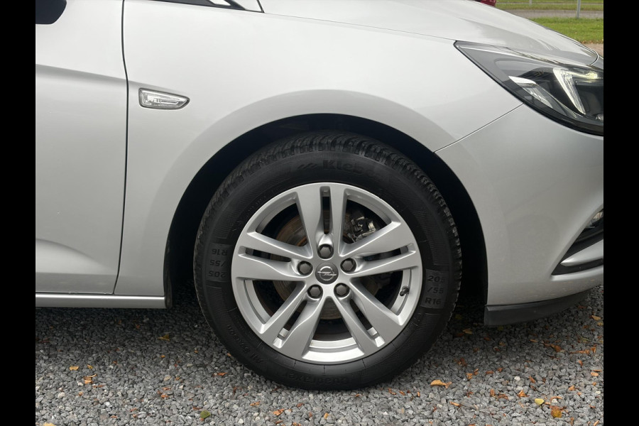 Opel Astra Sports Tourer 1.4 Online Edition ✓2e Eigenaar✓Trekhaak✓Carplay✓Navi✓Recent beurt gehad✓150pk✓Dealer Onderhouden✓6 Bak✓Pdc V+A✓Lm velgen✓Clima✓Cruise✓N.A.P✓Apk tot 06-2027